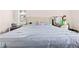 Bright bedroom with a large plush bed, tufted headboard, a window and a shelf full of accessories at 12546 Brookside St, Spring Hill, FL 34609