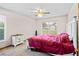 Comfortable bedroom with a ceiling fan, a large window, a carpet, and a nightstand at 12546 Brookside St, Spring Hill, FL 34609