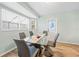 Dining room features a modern glass table with seating for six and bright natural light at 12546 Brookside St, Spring Hill, FL 34609