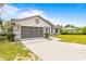 Beautifully maintained single-story home featuring a screened garage and a neatly kept front yard at 12546 Brookside St, Spring Hill, FL 34609