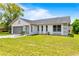 Charming single story home with a well maintained lawn and a screened garage and a tree in the yard at 12546 Brookside St, Spring Hill, FL 34609