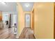Bright hallway featuring wood-look floors and fresh paint leading to various rooms in the home at 12546 Brookside St, Spring Hill, FL 34609