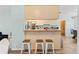 Open kitchen featuring a breakfast bar with stools and views of adjacent rooms at 12546 Brookside St, Spring Hill, FL 34609