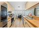 Open-concept kitchen and dining area with modern appliances and a view of the backyard at 12546 Brookside St, Spring Hill, FL 34609