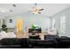 Large open living area featuring wood flooring, a ceiling fan, and ample space for relaxation at 12546 Brookside St, Spring Hill, FL 34609