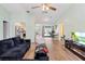 Bright and airy living area connecting to the kitchen with an entertainment system and cozy seating at 12546 Brookside St, Spring Hill, FL 34609