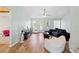 Spacious living room with wood flooring, ceiling fan, beanbag chairs, and views of windows and doorway at 12546 Brookside St, Spring Hill, FL 34609