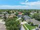Aerial view showing a lovely neighborhood with tree-lined streets and well-maintained homes on a sunny day at 1291 Blackrush Dr, Tarpon Springs, FL 34689