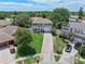 Aerial view of suburban home featuring a manicured lawn, two-car garage, and mature trees at 1291 Blackrush Dr, Tarpon Springs, FL 34689