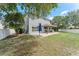 Large backyard with a patio area, providing ample space for recreation and leisure at 1291 Blackrush Dr, Tarpon Springs, FL 34689