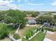 Aerial view of the backyard featuring a patio, pool, fence, lush lawn, garden, and mature trees. Perfect for outdoor living at 1291 Blackrush Dr, Tarpon Springs, FL 34689