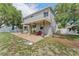 Expansive backyard features a covered patio, open green space, and privacy fencing at 1291 Blackrush Dr, Tarpon Springs, FL 34689