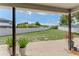 Covered patio overlooking a large backyard with a privacy fence and landscaping at 1291 Blackrush Dr, Tarpon Springs, FL 34689