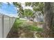 Backyard with large tree for shade on sunny day, featuring patio and surrounding privacy fence at 1291 Blackrush Dr, Tarpon Springs, FL 34689