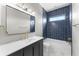 Contemporary bathroom showcasing blue tile, gold fixtures, and a sleek vanity at 1291 Blackrush Dr, Tarpon Springs, FL 34689