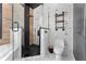 Bathroom features a glass enclosed shower, soaking tub, toilet, and industrial style shelves at 1291 Blackrush Dr, Tarpon Springs, FL 34689