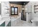 Modern bathroom with soaking tub, glass-enclosed shower and industrial style shelving at 1291 Blackrush Dr, Tarpon Springs, FL 34689