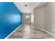 Bedroom featuring a bright blue wall and wood-look floors at 1291 Blackrush Dr, Tarpon Springs, FL 34689