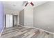 Bright bedroom featuring a ceiling fan and wood-look floors at 1291 Blackrush Dr, Tarpon Springs, FL 34689