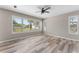Serene bedroom with wood-look floors and windows providing ample natural light at 1291 Blackrush Dr, Tarpon Springs, FL 34689