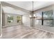 Bright dining area with modern light fixture and large windows at 1291 Blackrush Dr, Tarpon Springs, FL 34689