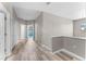 Well-lit hallway showcasing wood-look flooring, neutral walls, and multiple doorways at 1291 Blackrush Dr, Tarpon Springs, FL 34689