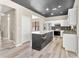 Modern kitchen with white cabinets, island and black countertops at 1291 Blackrush Dr, Tarpon Springs, FL 34689