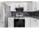 Stainless steel oven nestled between white cabinets and stone countertops at 1291 Blackrush Dr, Tarpon Springs, FL 34689