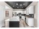 Modern kitchen with white cabinets, stainless steel appliances, and a stunning island with marble countertop at 1291 Blackrush Dr, Tarpon Springs, FL 34689