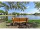 Scenic view of the lake with a bench to sit and enjoy the tranquility, natural beauty, and peaceful surroundings at 1291 Blackrush Dr, Tarpon Springs, FL 34689