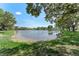 Capture the serenity of lake with trees, a walking path, and lush lawn, and an inviting spot for relaxation and enjoyment at 1291 Blackrush Dr, Tarpon Springs, FL 34689