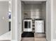 Convenient laundry room featuring modern washer and dryer units and shelving at 1291 Blackrush Dr, Tarpon Springs, FL 34689