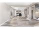 Open living space with modern wood floors, connecting to the kitchen, staircase, and dining areas for seamless living at 1291 Blackrush Dr, Tarpon Springs, FL 34689