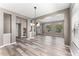Bright and airy living room with wood flooring, showcasing an open layout to the staircase and entryway with natural light at 1291 Blackrush Dr, Tarpon Springs, FL 34689