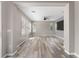 Open living area with wood-look floors, large windows, and neutral tones at 1291 Blackrush Dr, Tarpon Springs, FL 34689