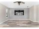Comfortable living room with a mounted TV, wood-look floors, and neutral decor at 1291 Blackrush Dr, Tarpon Springs, FL 34689