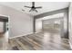 Open-concept living room with natural light and stylish wood-look flooring at 1291 Blackrush Dr, Tarpon Springs, FL 34689