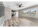 Inviting living room with natural light, wood-look floors, and views of the backyard at 1291 Blackrush Dr, Tarpon Springs, FL 34689