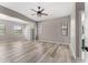 Spacious living room with ample natural light and wood-look floors at 1291 Blackrush Dr, Tarpon Springs, FL 34689