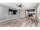 Open-concept living room with wood-look floors adjacent to a modern kitchen at 1291 Blackrush Dr, Tarpon Springs, FL 34689