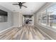Light-filled living room showcasing wood-look floors and a view into the kitchen at 1291 Blackrush Dr, Tarpon Springs, FL 34689