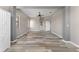 Living room featuring natural light, neutral walls, and wood-look floors at 1291 Blackrush Dr, Tarpon Springs, FL 34689