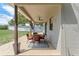 Covered patio featuring a ceiling fan and outdoor dining set, perfect for enjoying meals outdoors at 1291 Blackrush Dr, Tarpon Springs, FL 34689
