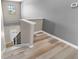Bright staircase featuring wood-look flooring and a window offering natural light at 1291 Blackrush Dr, Tarpon Springs, FL 34689