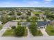 Aerial view of the neighborhood with tree-lined streets, well-maintained houses, and lush greenery at 13384 Brighton St, Spring Hill, FL 34609