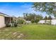 Spacious backyard with lush green grass, mature trees, and landscaping at 13384 Brighton St, Spring Hill, FL 34609