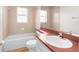 Bathroom featuring white cabinets, tile floors, and shower-tub combo at 13384 Brighton St, Spring Hill, FL 34609