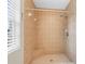 Tiled shower with a built-in seat with great lighting and easy to clean surfaces at 13384 Brighton St, Spring Hill, FL 34609