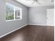 An airy bedroom with hardwood floors featuring a window view and access to a private closet at 13384 Brighton St, Spring Hill, FL 34609