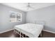 Bedroom features neutral walls, dark wood floors, ceiling fan, and a large window at 13384 Brighton St, Spring Hill, FL 34609